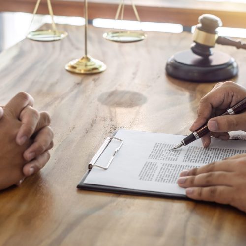 Law, lawyer attorney and justice concept, Consultation between a male lawyer and client, giving advice and prosecutions about the regarding real estate, report of the important case in the workplace.